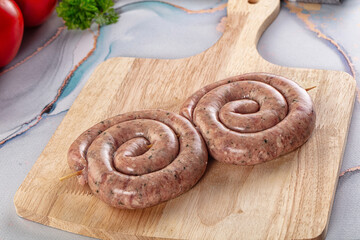 Raw meat pork and beef swirl sausages