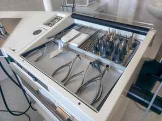 Surgical instruments arranged neatly on a medical tray in a clinical setting