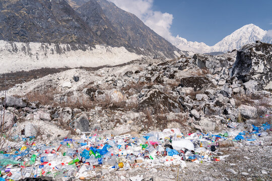 Garbage and plastic bottles scattered below glacier on Manaslu Circuit, Bimthang, Nepal