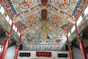 The serene interior of Yanshui Catholic Church in Tainan, Taiwan, featuring wooden pews, arched...