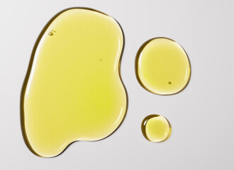 Avocado oil droplets, yellow liquid serum texture, 3d rendering facial oil drops skin care beauty product