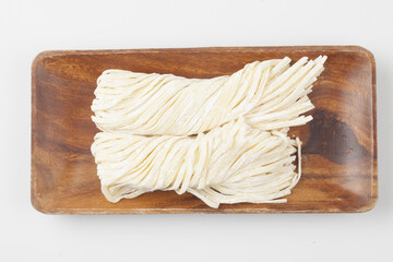 A food product made by kneading flour, buckwheat flour, potato flour, etc. and then stretching the dough into thin, long pieces by hand or machine.
