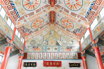 The serene interior of Yanshui Catholic Church in Tainan, Taiwan, featuring wooden pews, arched...