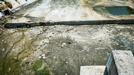 Dry Polluted Canal with Algae.