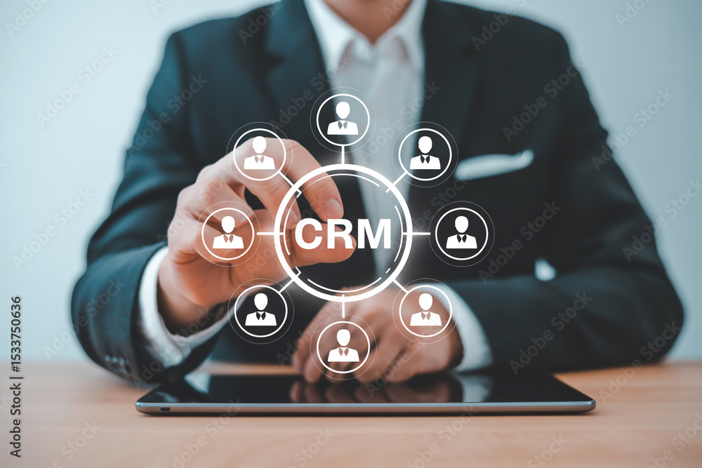 Poster man in suit touching crm interface on tablet with customer icons around the central crm text