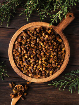 bee bread on a wooden board on a wooden background. top view
