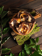 inner ear dry beef ear shells on wooden dark background. top view. snack for dogs