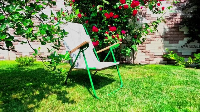Folding chair in the garden outdoors on a nice summer day