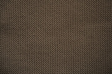 Fototapeta premium brown knitted fabric texture, macro texture of brown wool fabric, geometric knitted pattern of elastic band with knitting needles as background