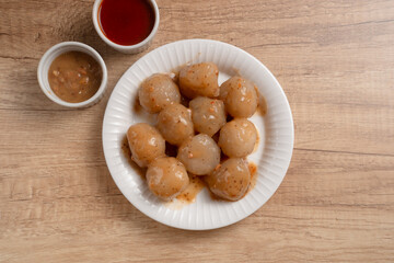 Cilok is a snack made from tapioca flour and served with savory and spicy peanut sauce. Perfect for recipes, articles or any cooking content.