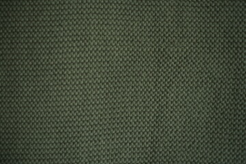 marsh texture of knitted fabric, macro texture of green wool fabric, geometric knitted pattern of crocheted elastic as a background