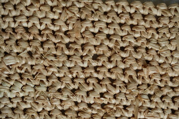 macro texture of summer brown paper hat as background, close up texture of panama hat, paper for panama hat