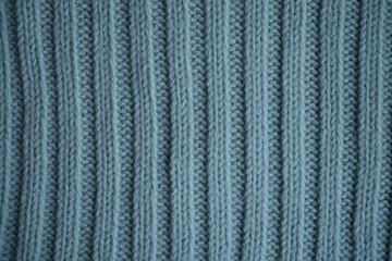 blue texture of knitted fabric, macro texture of blue woolen fabric, geometric knitted pattern of crocheted elastic as a background