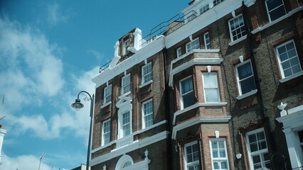 A highly detailed, professional photograph of a building with a clock on top of it captured with artistic lighting and excellent composition. the scene features  under moody and dramatic conditions.