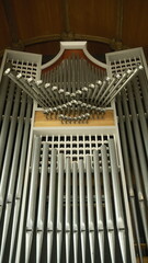 A highly detailed, professional photograph of a close up of a bunch of metal pipes captured with artistic lighting and excellent composition. the scene features  under moody and dramatic conditions.