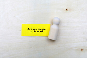 Magnifying glass and paper tag with the question words Are you aware of change?