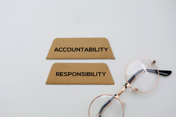 Paper with the words accountability and responsibility. Accountability refers to being responsible or liable for actions, decisions, and their consequences
