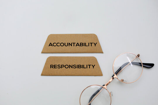 Paper with the words accountability and responsibility. Accountability refers to being responsible or liable for actions, decisions, and their consequences