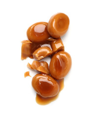 Tasty sweet candies and caramel sauce isolated on white, top view