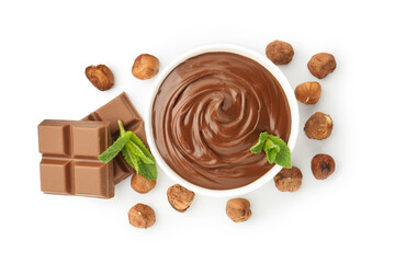 Tasty chocolate spread with mint in bowl and hazelnuts isolated on white, top view