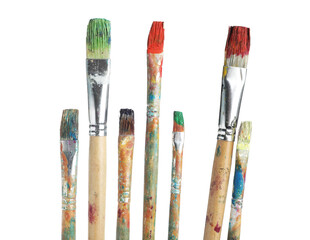 Obraz premium Brushes with different paints isolated on white