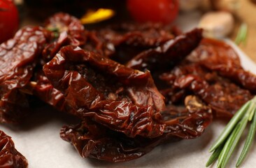 Tasty sun dried tomatoes and fresh vegetables on table, closeup