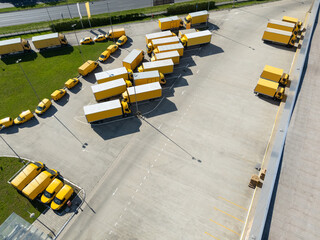 Delivery vans and trucks hub. Fleet of yellow post vehicles