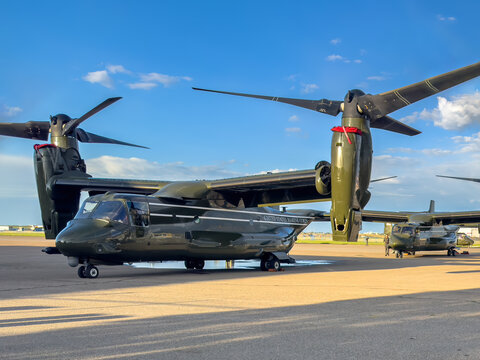 Calgary, Alberta, Canada. Jun 14, 2025. U.S. Marine Corps MV-22 Ospreys lined up on a runway during daylight operations, showcasing tiltrotor technology and military readiness.