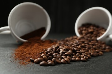 Aromatic ground coffee and beans on black table, closeup