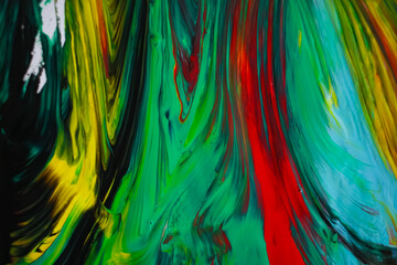 Abstract background with acrylic or oil paints on canvas. Black, blue, green, red, yellow.