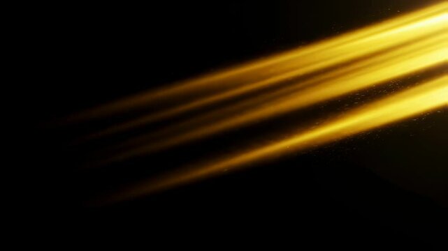 Golden light rays with dust particles passing through a dark background. Abstract sunbeam flare effect for overlay or atmospheric design footage.