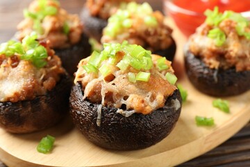Many delicious stuffed mushrooms on table, closeup