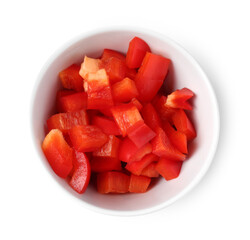 Pieces of fresh red bell peppers in bowl isolated on white, top view