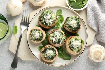Tasty stuffed mushrooms served on light table, flat lay