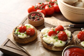Tasty stuffed mushrooms served on wooden table, closeup