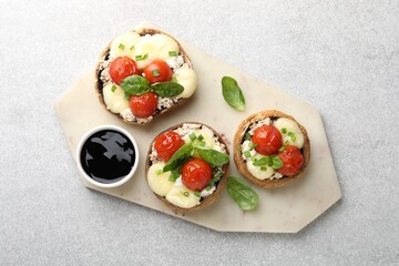 Tasty stuffed mushrooms served on light table, top view
