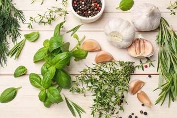 Different fresh herbs and spices on white wooden table, flat lay