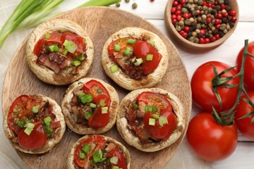 Tasty stuffed mushrooms served on white wooden table, flat lay