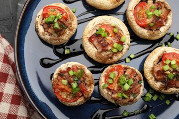 Tasty stuffed mushrooms served on black table, top view