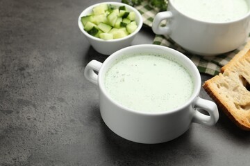 Tasty cucumber soup served on grey table, closeup. Space for text