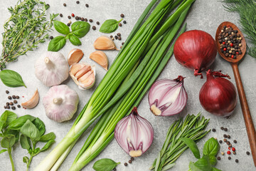 Different herbs and spices on grey table, flat lay