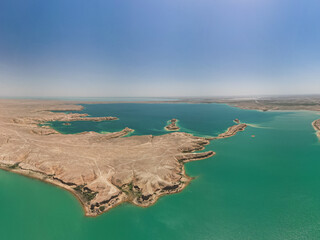 Turquoise bays, arid terrain and islands of Kuimazar Reservoir Uzbekistan summer