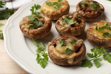 Tasty stuffed mushrooms served on table, closeup