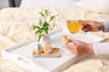 Woman having delicious breakfast in bed, closeup
