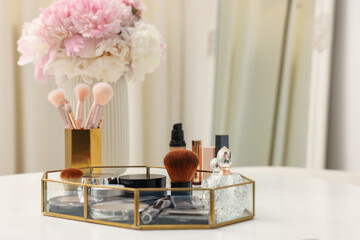 Tray with different makeup products on white table indoors. Space for text