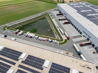 Logistic center with solar panels on roof. Aerial view