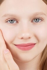 Close-up portrait beautiful Caucasian girl posing look at camera on studio, charming smile, natural beauty Gen Alpha. Face. Adverts for skincare cosmetics for teengers or children. Self care treatment