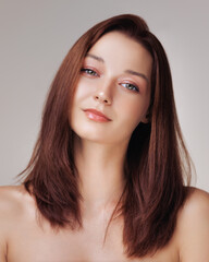 Naklejka premium Young Woman With Silky Straight Hair And Radiant Skin Smiling Calmly