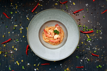 close up of a plate of pasta with shrimp inside