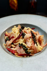 close up of a plate of pasta with green pepper and bacon inside